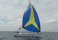 Diese Segelyacht ist mit einem blau-gelben Spinnaker von Sailselect unterwegs.